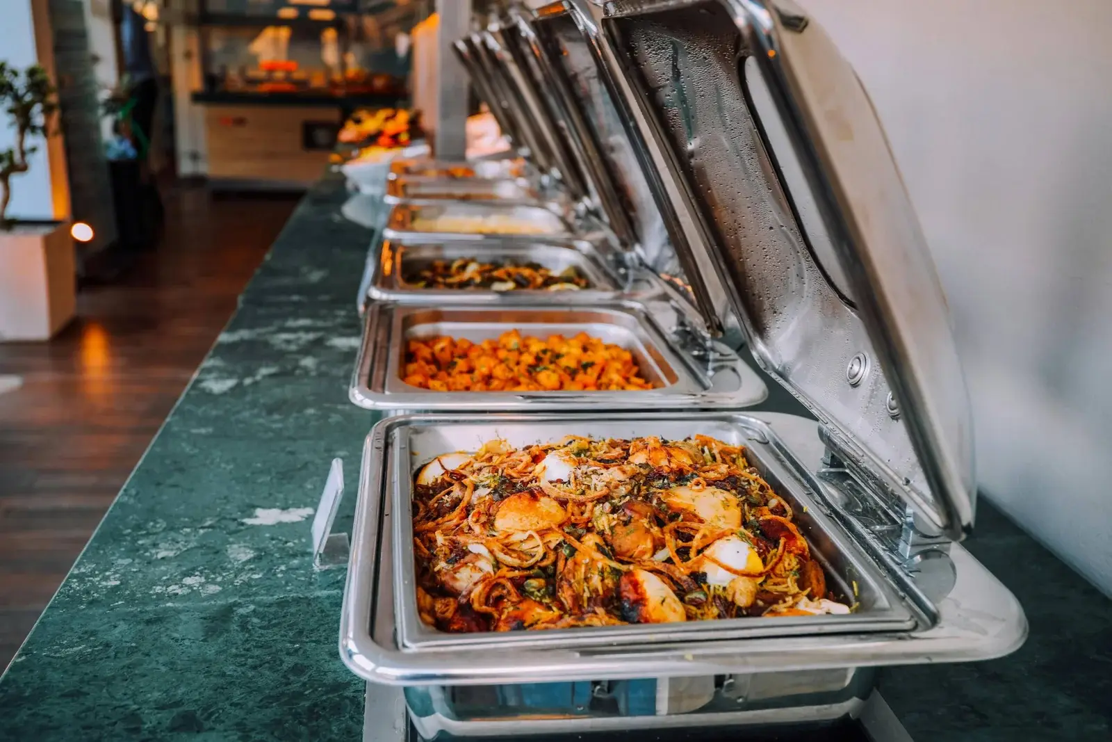 Chef plating an authentic Indian dish at Indian Eatery