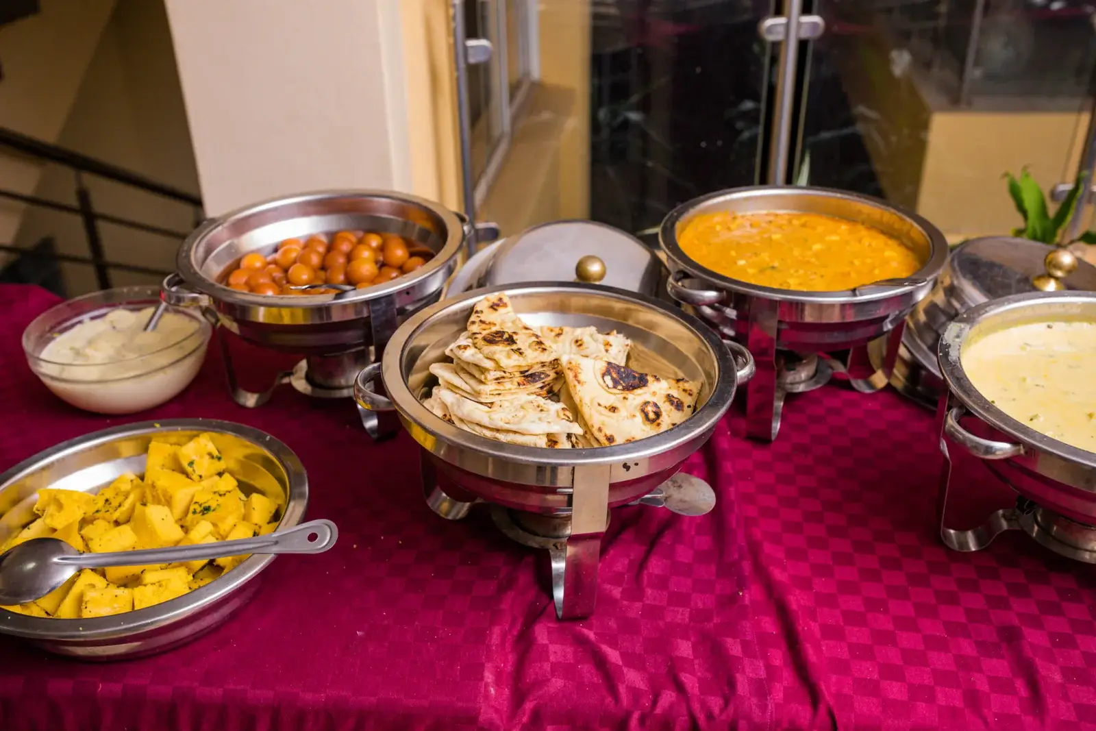 Foil to-go trays filled with Indian dishes