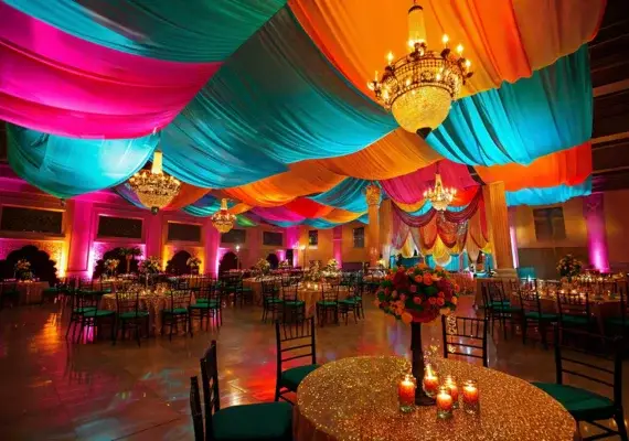 An outdoor event under white tents with tables set for guests